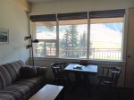 Sleeper sofa pulled out in living area with winter ski slope view